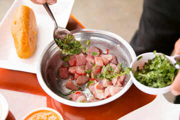 Wall Mural - Preparing a delicious Peruvian sea bass ceviche in the fishing port of Chorríos in Lima.