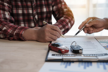 Wall Mural - Loan approver, businessman in suit, man giving car keys after car loan approval and contract signing