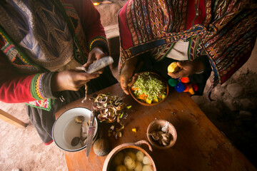 Wall Mural - Cooking a traditional Andean vegetable soup before a Pachamanca feast with a Quechua tribe in the Sacred Valley, Peru.