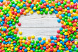 © sosiukin - Mixed collection of colorful candy, on colored background. Flat lay, top view. frame of colorful chocolate coated candy