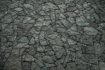 Wall Mural - Texture of a stone wall, roads from stones, bricks, cobblestones, tiles with sandy seams of gray ancient natural grey with sharp edges. The background.