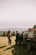 © BGStock72 - Young couple relaxing on a terrain vehicle hood at countryside