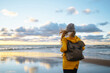 © maxbelchenko - Happy tourist in a yellow jacket  enjoying sea landscape. Travelling, lifestyle, adventure.