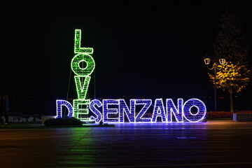 Wall Mural - Desenzano del garda at night and lettering with light