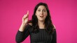 © Robert Peak - Portrait of thinking, smart puzzled pensive young hipster woman 20s looks around thinks comes up with ideas raised finger thumbs up isolated on pink background studio portrait