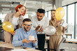 © dsheremeta - Business team celebrating a birthday of collegue in the modern office.