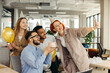 © dsheremeta - Business team celebrating a birthday of collegue in the modern office.