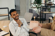 © dsheremeta - A young Hindu man is about to blow out candles on a cake and make a wish during a birthday celebration with colleagues. Colleagues celebrate a birthday in the office