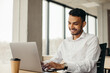 © dsheremeta - Young hindu businessman at workplace with laptop. Office work.