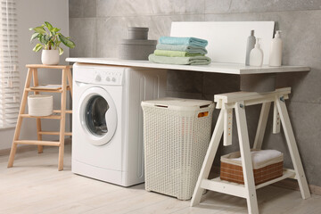 Stylish laundry room with modern washing machine. Interior design