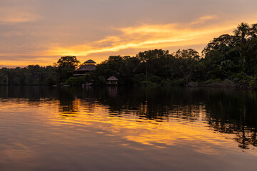 Wall Mural - Amazon rainforest lodge at sunset in the midst of the jungle, Yasuni national park, Ecuador.