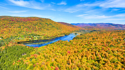 Wall Mural - Lake tucked into colorful peak fall mountains in New York