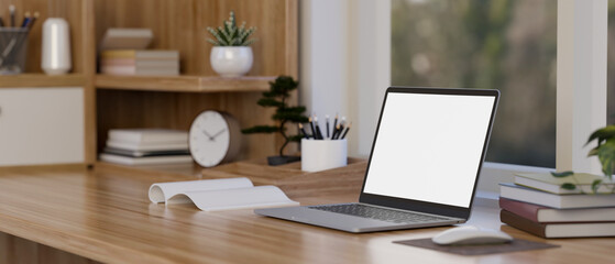 Wall Mural - Laptop mockup is on the wooden table with decor against the window. minimalist workspace.