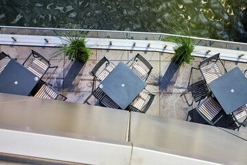 Looking down on dining patio tables next to water