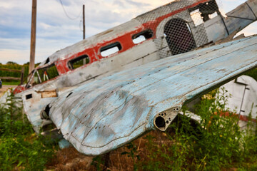 End of wing on completely destroyed and abandoned airplane in field