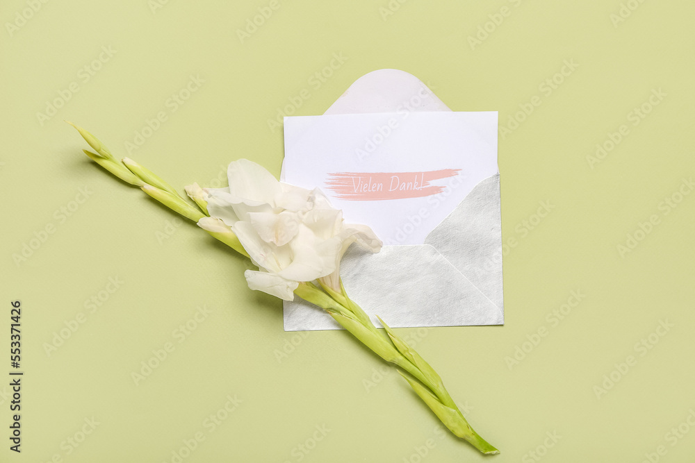 Card with text VIELEN DANK and gladiolus flower on green background