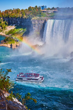 Misty Niagara Falls With Rainbow And Tourist Ship Near Horseshoe Falls