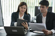 © aekachai - Group of asian business people working, discussing new projects together, having fun at the office.