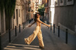 © Look! - In full length young caucasian girl funny walking at european street during spring day. Brunette wears stylish casual clothes. Great mood concept.