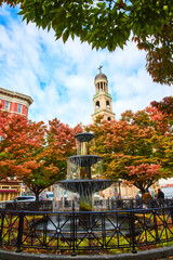 Poster - New York City stunning fountain surrounded by fall trees with Christian church steeple behind