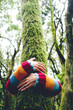 © simona - Environment and nature care people concept activity. One woman hugging and embracing green musk covered trunk tree in the forest woods. Female and outdoor leisure activity. Stop deforestation