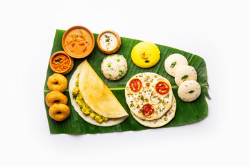 South Indian Masala Dosa, Uttapam, Idli vada sambar, semolina halwa, upma served over banana leaf