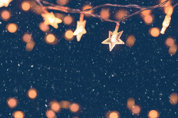 Wall Mural - defocus christmas stars lights with falling snow, snowflakes, winter and new year holidays. copy spa