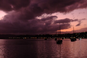 Wall Mural - Gloomy sunset on the water.