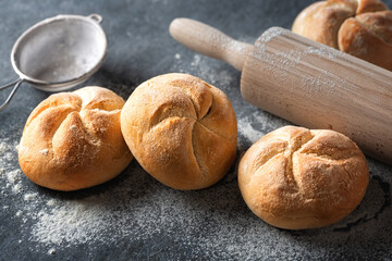 Aufkleber - Set of fresh small bun bread on the dark table with rolling pin. Home baking concept