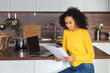 © kucherav - Satisfied African American woman received a statement from the bank about the closing of the loan, mortgage repayment, good news concept
