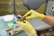 The orthodontist prepares a special paste for making an impression of the patient's teeth