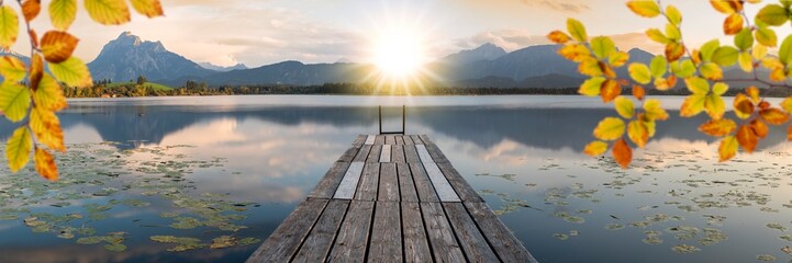 Poster - panoramic view over lake with jetty in sunset