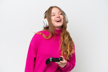 Young pretty woman playing with a video game controller isolated on white background laughing