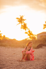 Wall Mural - Cute teen beautiful girl on tropical seashore at sunset