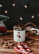 Coffe in christmas mug with cream and chocolate on the wood backround