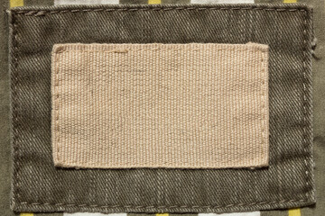 empty beige fabric patch on men's trousers