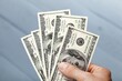 © BillionPhotos.com - Hand holding money Dollars bills