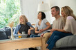 © PhotoAlto - Portrait of diverse group of friends gathered at home to watch a movie