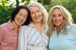 © PhotoAlto - Three senior women posing together for group photo outdoors