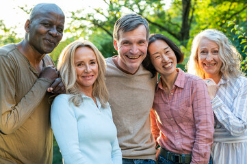 Wall Mural - Fun diverse group of middle-aged friends hanging out in backyard at sunset