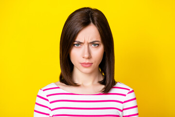 Wall Mural - closeup photo of young funny attractive girl looking you gloomy bad mood isolated on yellow color ba