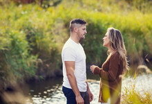 Husband And Wife Spending Quality Time Together Outdoors Near A Stream In A City Park And Having A Serious Discussion; Edmonton, Alberta, Canada