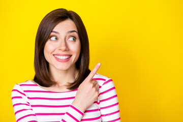 Wall Mural - closeup photo of young attractive girl directing look empty space nice advertisement isolated on yel