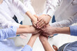 © New Africa - Group of people holding hands together indoors, above view. Unity concept