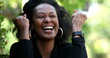 © Marco - Ecstatic woman celebrating success and achievement, african black ethnicity