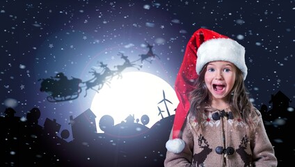 Wall Mural - Cute child in Santa Claus hat at night