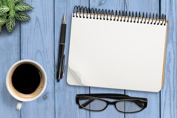 Wall Mural - Blank notebook and cup, glass on office table.