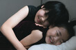 © Yumiko Kinoshita - sisters  laughing on a bed