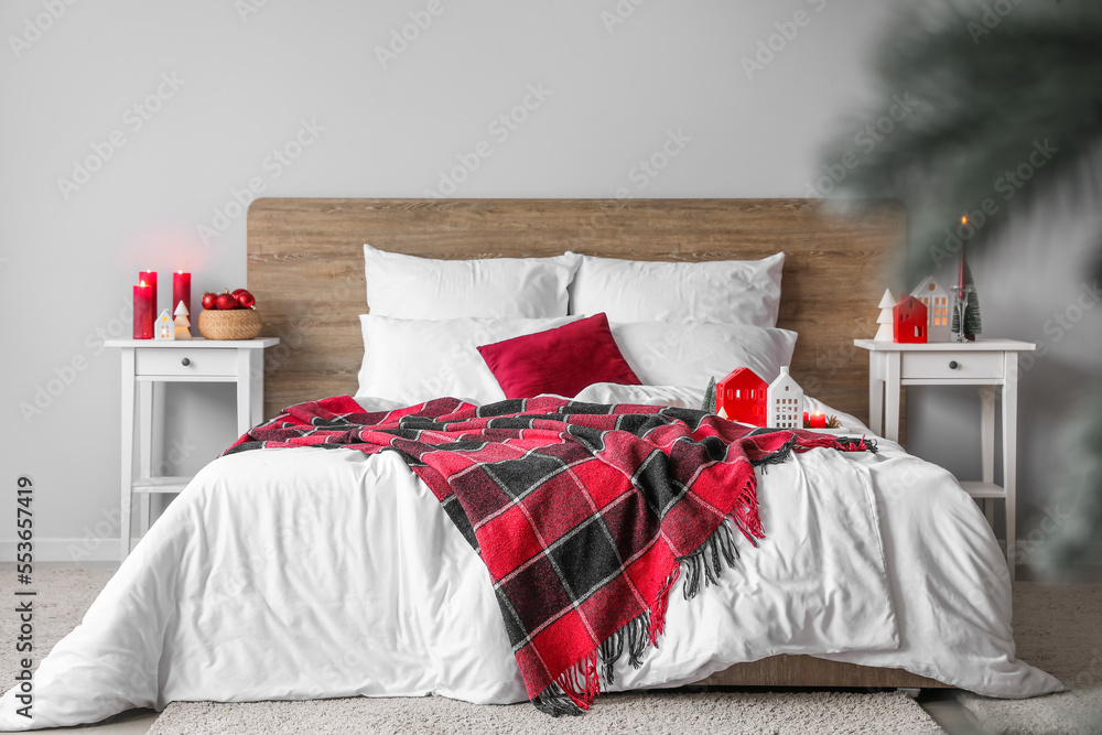 Interior of bedroom with Christmas trees and candle holders