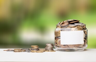 Sticker - Golden coins in jar on wooden desk